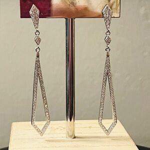 Moissanite drop earrings set in rhodium over 925 Sterling Silver.